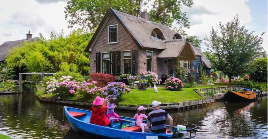 From Amsterdam: Giethoorn Guided Day Trip with Canal Cruise - The coach ride: stroopwafel, countryside views, and guide stories