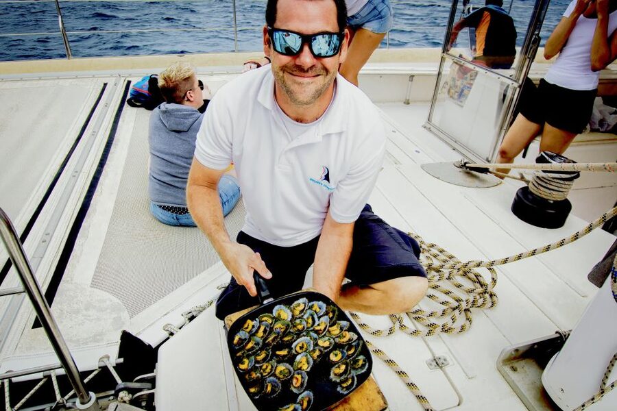 From Lanzarote: Sailing Day Trip Around La Graciosa - The catamaran cruise: champagne welcome, snacks, and the shoe-off culture