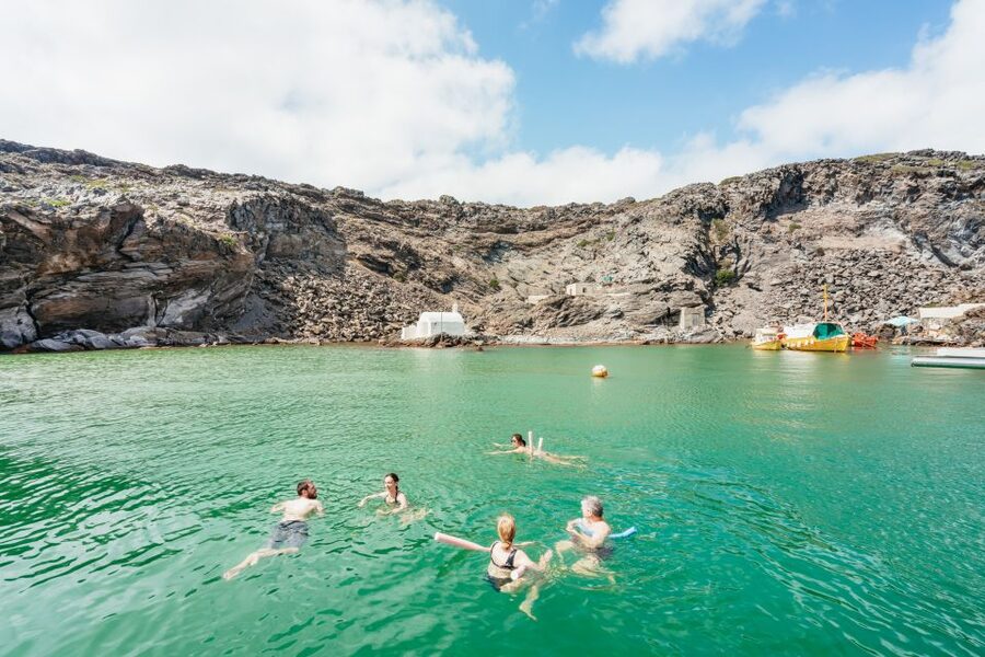 Santorini: Luxury Catamaran Day Trip with Meal and Open Bar - First swim zones: Red Beach coast and White Beach sea caves snorkeling