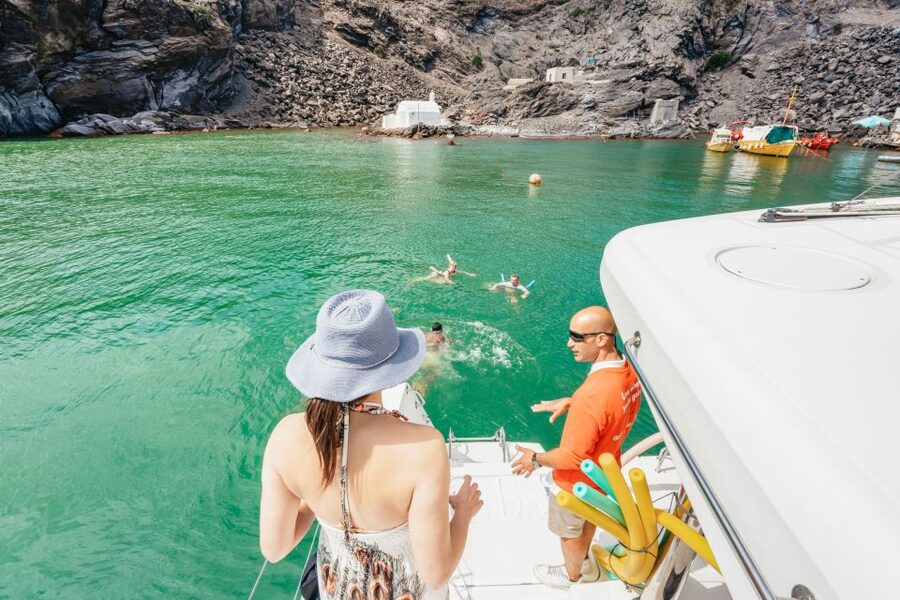 Santorini: Luxury Catamaran Day Trip with Meal and Open Bar - Sailing past Palia Kameni, Nea Kameni, and the caldera below Fira